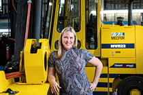 Éloïse Harvey, CEO of EPIQ Machinery, in front of a forklift