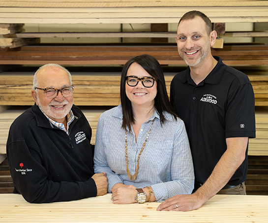 Carmi Mooser, co-owner of Airwood Flooring Accessories, with two employees