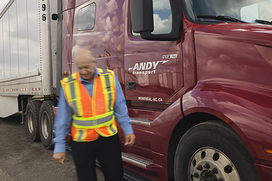 an Andy Transport employee standing in front on a company truck
