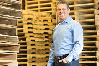 Raed Bechara - Founder of Industrie de Palettes Standard (IPS), in front of wood pallets