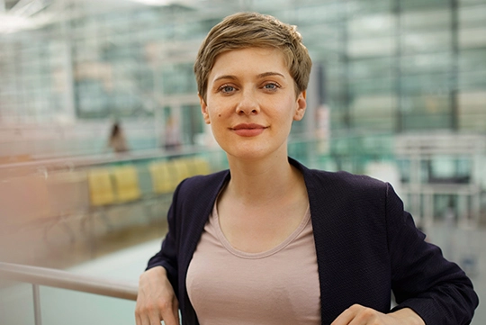 businesswoman leaning on a handrail outside