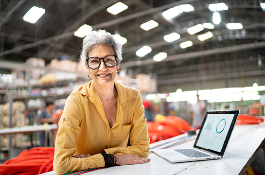 woman smiling, computer with a graph on screen