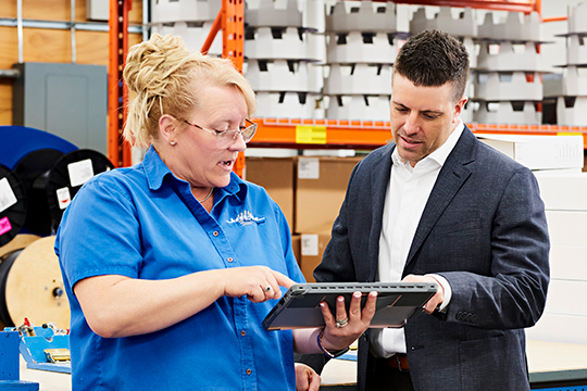 Matthew J. Roberts, owner of Heat Line, talking with an employee