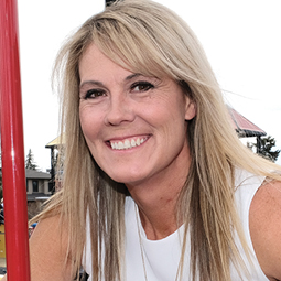 Owner of Park N Play Design Company Michelle Poffenroth, standing in playground structure