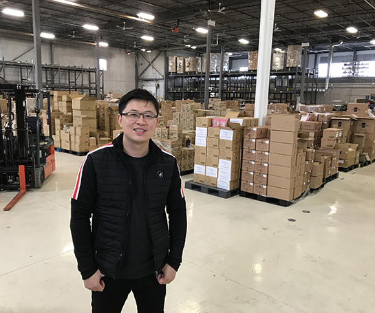 Ryan (Qian) Peng, President and CEO of Kormet Inc., in his warehouse