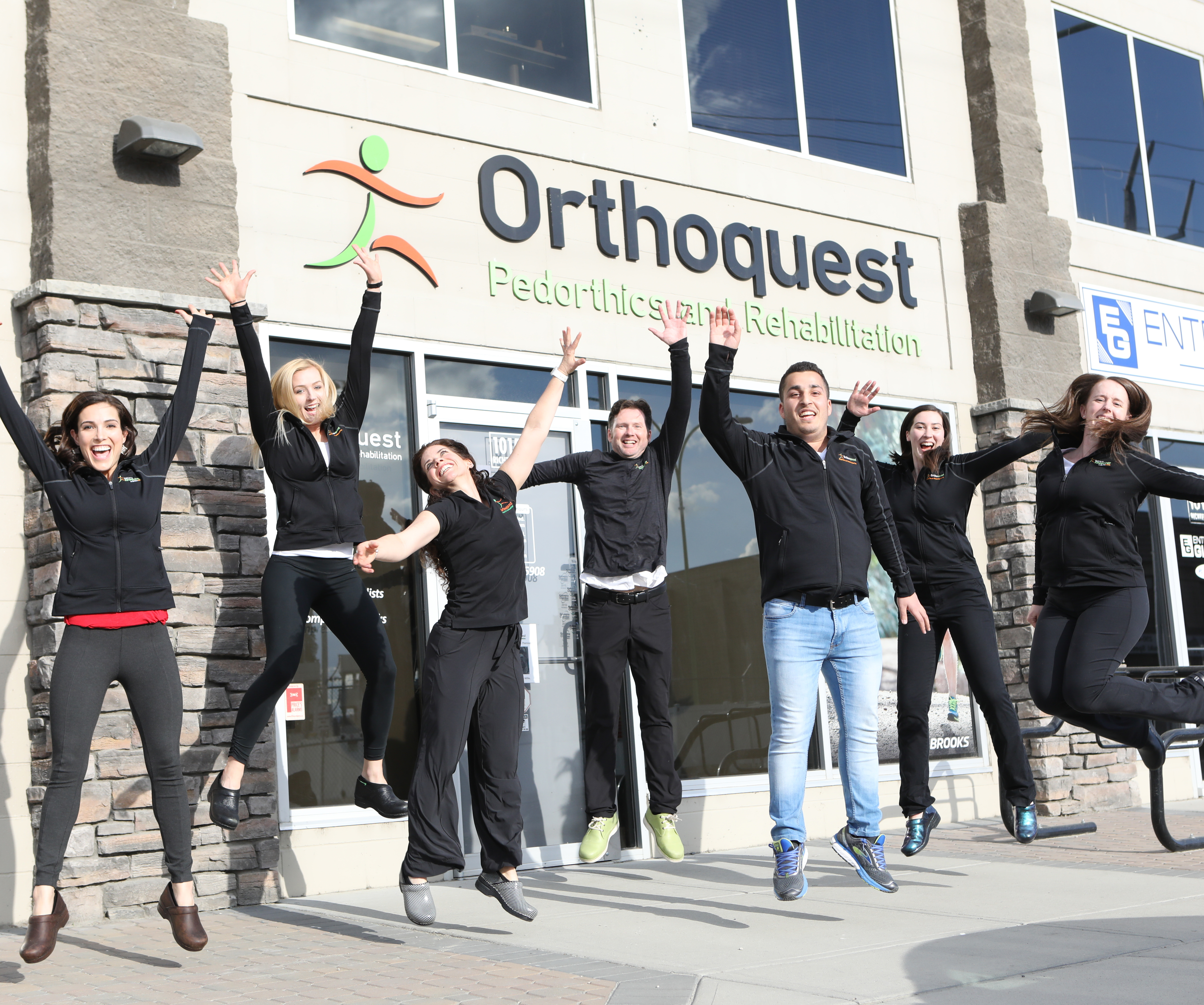 Orthoquest's team members jumping in joy