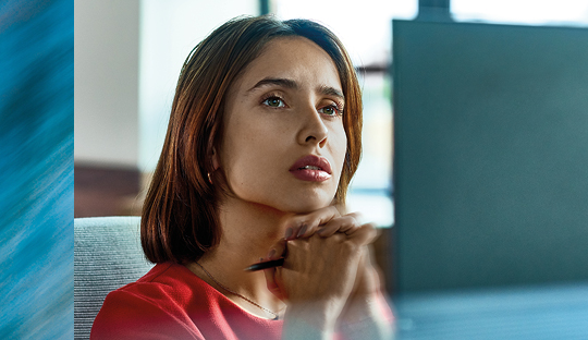 Woman in front of her computer thinking about her digital future