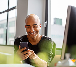 Entrepreneur interacting on social media on his smartphone