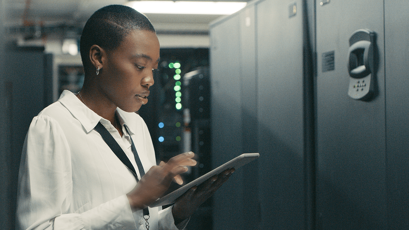 black women looking at an ipad in a server room