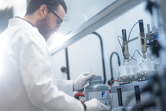 white young man laboratory technician preparing a chemical solution
