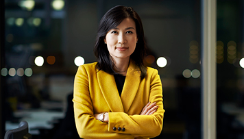 asian woman yellow blazer crossed arms