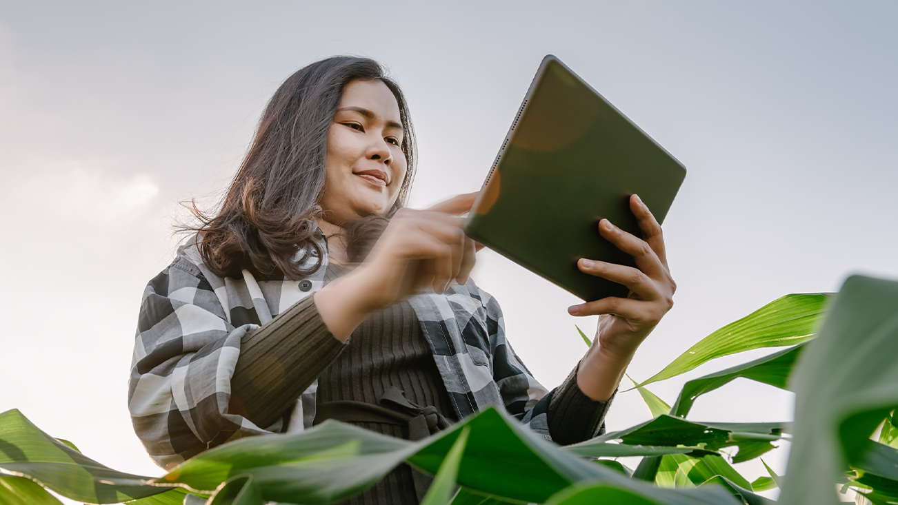 women in a field with an ipad