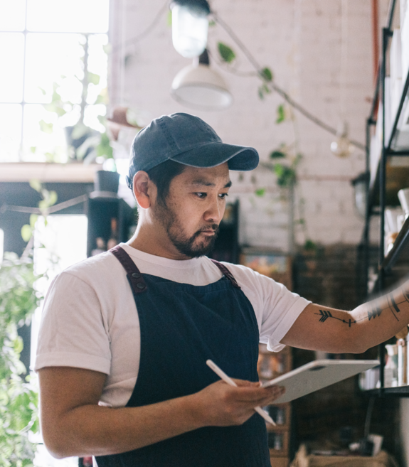 Coffee shop owner looking at his inventory
