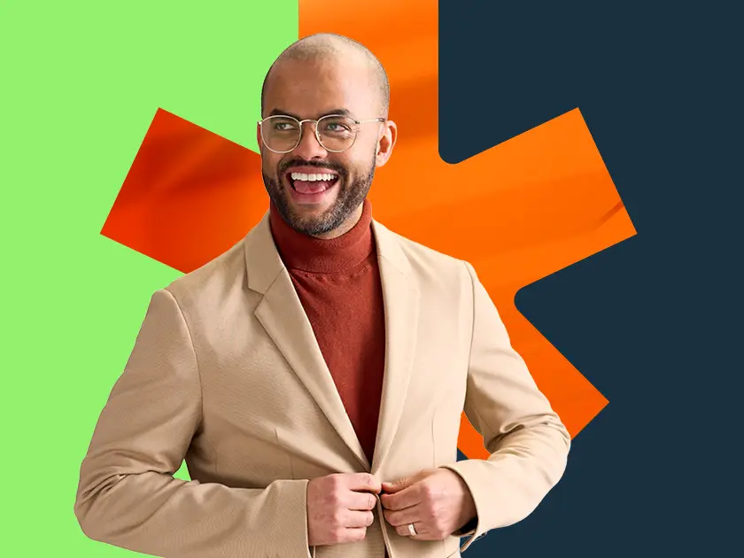 Portrait of a happy employee in a beige jacket on an orange maple leaf