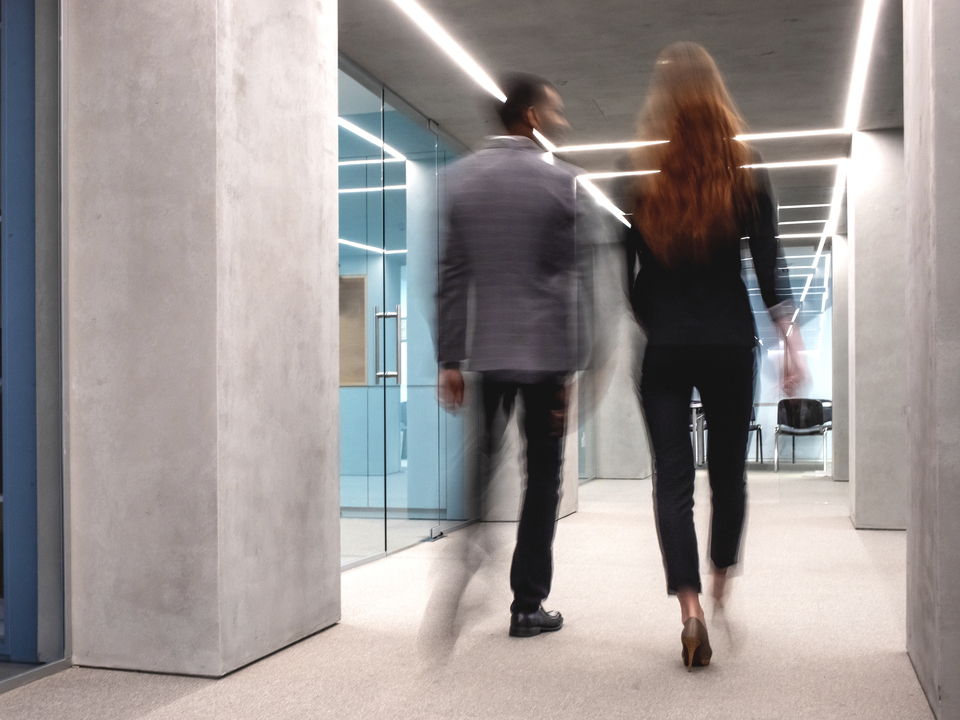 Coworkers talking while walking to a meeting