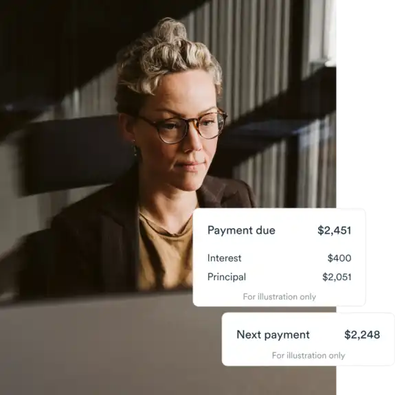 Woman wearing glasses sitting inoffice