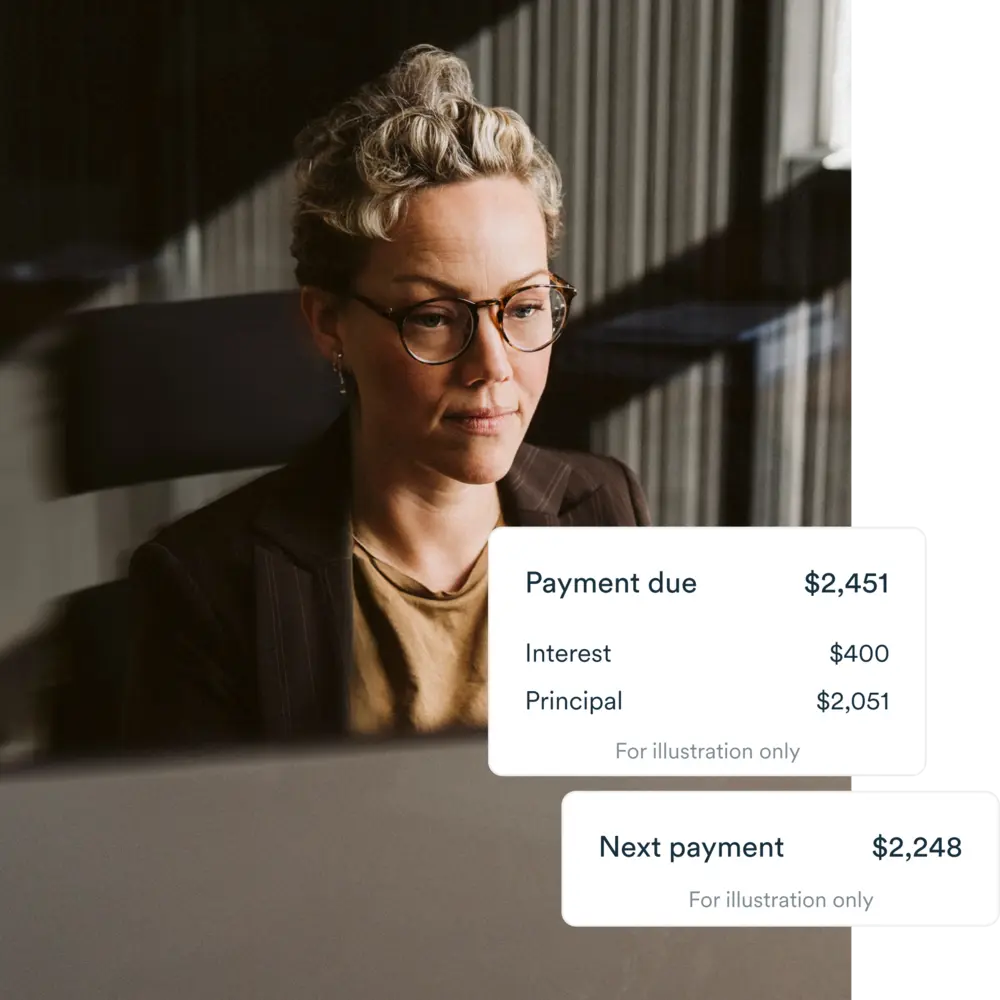 Woman wearing glasses sitting inoffice