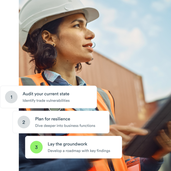Woman on export site with helmet, tablet and an orange vest