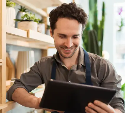 Florits using digital tablet in flower shop