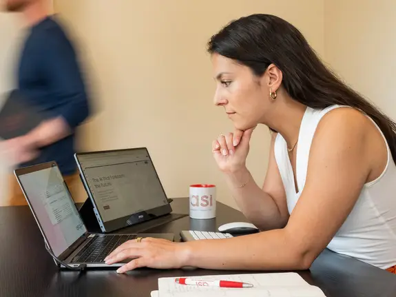 Advanced Symbolics employees working in an office