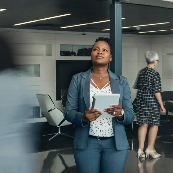 businesswoman holding tablet, standing in office